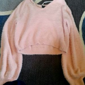 A pink fluffy crop top sweater